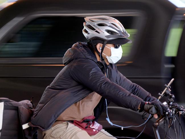 People wearing masks outside the Alfred Hospital, Melbourne. Picture: Andrew Henshaw