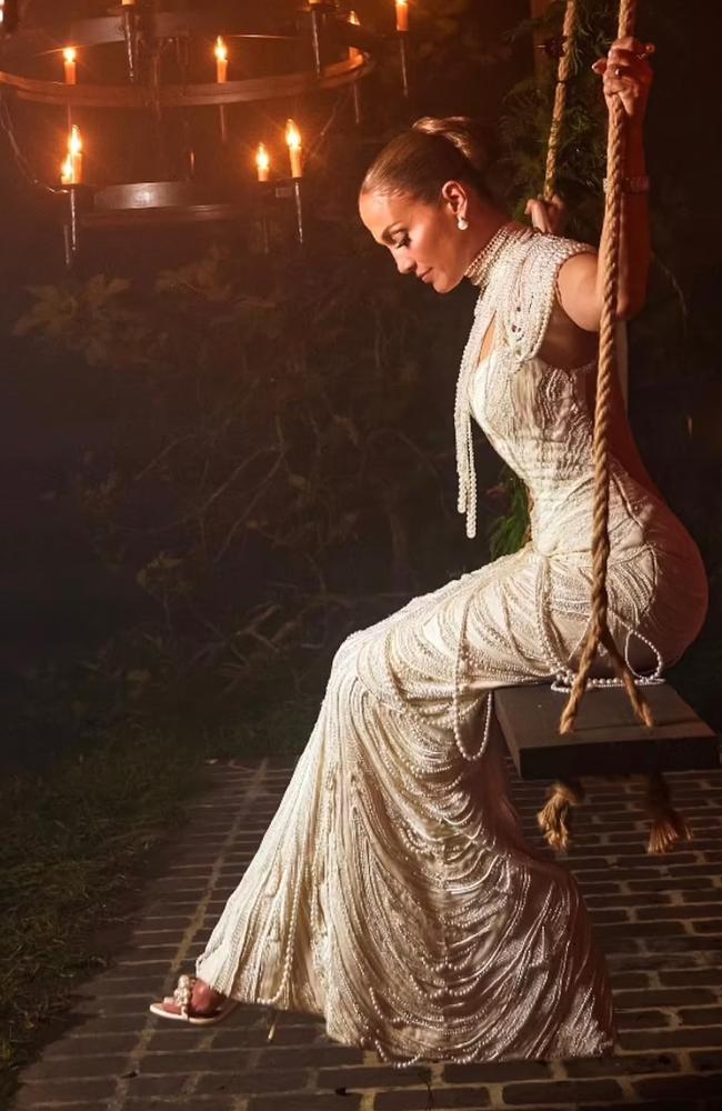 Jennifer Lopez sits on a swing in her pearl-adorned third wedding gown. Picture: OntheJLo.com