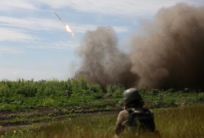 Ukrainian servicemen fire a rocket from a BM-21 Grad multiple rocket launcher towards Russian positions, near Bakhmut