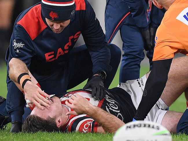 Sam Verrills of the Roosters is assisted after sustaining an injury during the Round 7 NRL match between the Sydney Roosters and the St George Illawarra Dragons at Bankwest Stadium in Sydney, Friday, June 26, 2020. (AAP Image/Dan Himbrechts) NO ARCHIVING, EDITORIAL USE ONLY