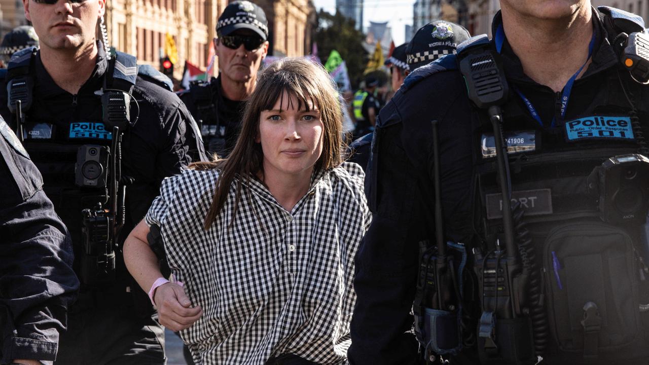 MELBOURNE, AUSTRALIA - NCA NewsWire Photos - 16 MARCH 2024: Extinction Rebellion activists get arrested by members of Victoria Police as they blocked the Flinders Street Station intersection Picture: NCA NewsWire / Diego Fedele