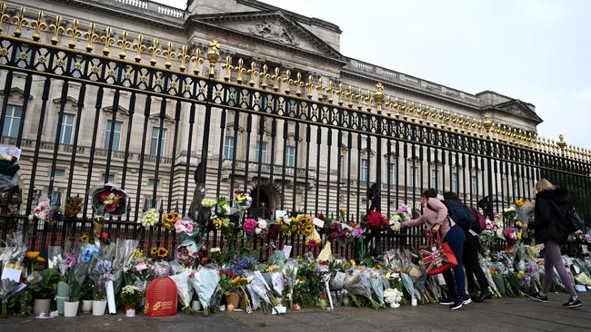 Tributes are placed outside Buckingham Palace for Queen Elizabeth, who died on Thursday. Picture: Getty Images