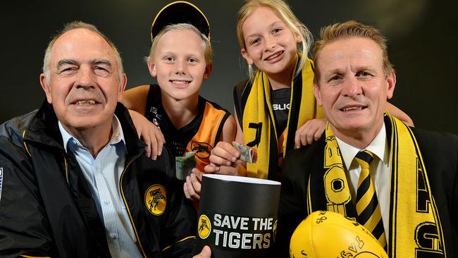 Glenelg Football Club legend Peter Carey, fans Joe Chigwidden (11) and Summer Ryan (12), with club president Nick Chigwidden at the launch of the club's 'Save the Tigers' fund. Picture: Bianca De Marchi