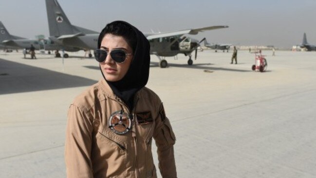 TO GO WITH AFGHANISTAN-UNREST-WOMEN-AVIATION BY ANUJ CHOPRA In a picture taken on April 26, 2015, Afghanistan's first female pilot Niloofar Rahmani, 23, poses for a photograph at an Air Force airfield in Kabul. With a hint of swagger in her gait, Afghanistan's first female pilot since the ouster of the Taliban is defying death threats and archaic gender stereotypes to infiltrate an almost entirely male preserve. AFP PHOTO / SHAH Marai