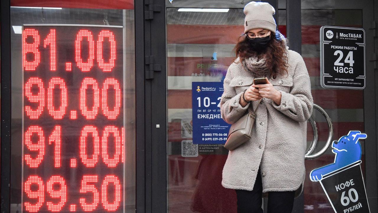 A woman walks past a currency exchange office in central Moscow. Picture: Alexander Nemenov / AFP