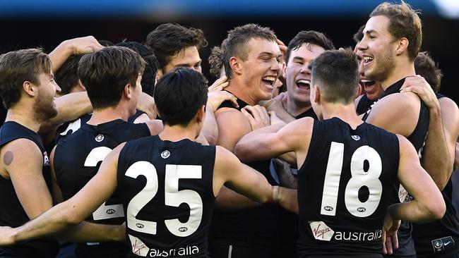 Cripps is swamped by teammates after his matchwinning effort. Picture: Getty Images