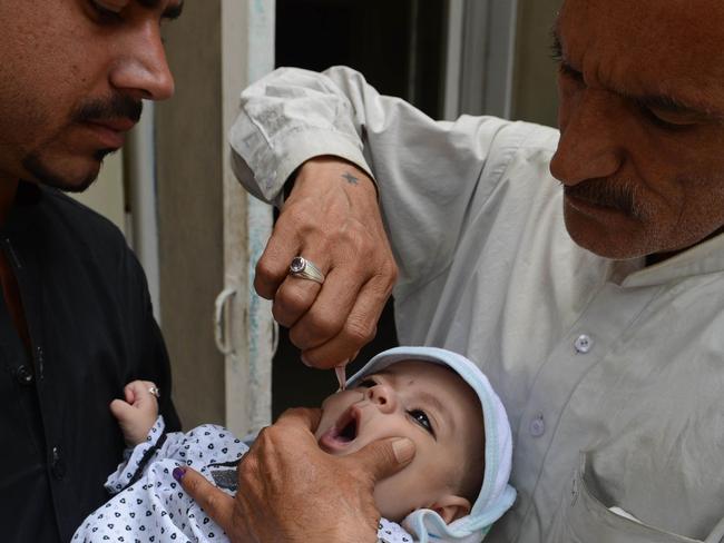 A Pakistani health worker administers polio vaccine drops to a child in Quetta. Picture: AFP/Banaras Khan