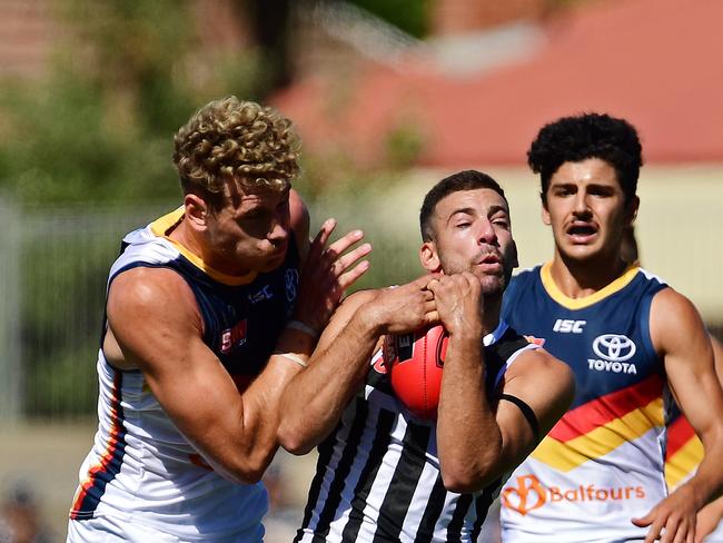 31/03/18 - SANFL: Port Adelaide v Adelaide at Alberton Oval.  Crows Harrison Dear lays a big hit on Ports Jimmy Toumpas.Picture: Tom Huntley