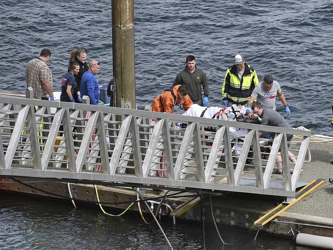 Emergency response crews transport an injured passenger to an ambulance at the George Inlet Lodge docks, in Ketchikan, Alaska. Picture: AP