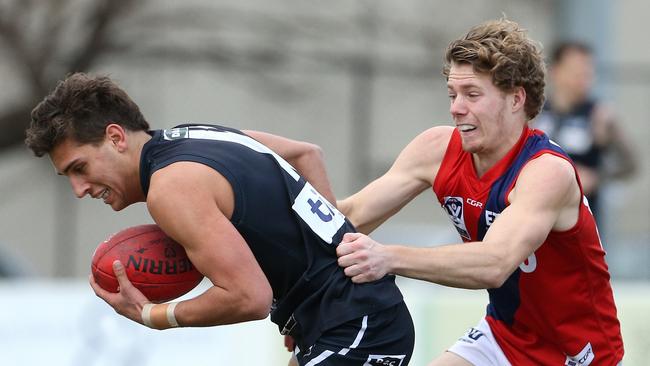 Alexander Federico of Northern is tackled by Joshua Guthrie of Coburg during VFL footy: Northern Blues v Coburg on Saturday, August 11, 2018, in Epping, Victoria, Australia. Picture: Hamish Blair