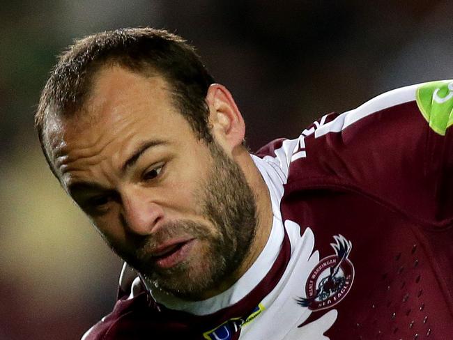 Manly's Brett Stewart tackled by his brother Rabbitoh's Glenn Stewart during the NRL game between the Manly Warringah Sea Eagles and the South Sydney Rabbitohs at Brookvale Oval .Picture Gregg Porteous