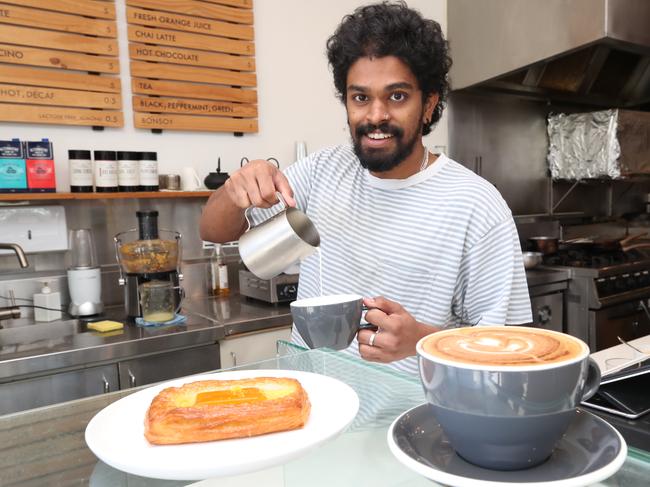 Holy Egg in Southport is one of the cafes open all Easter weekend. Charles Konikkarra at work serving coffees. Picture Glenn Hampson