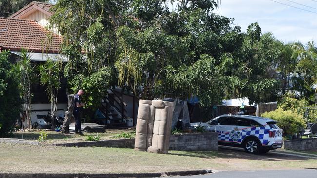 Police at the Brisbane St, Barney Point, property on Friday morning.
