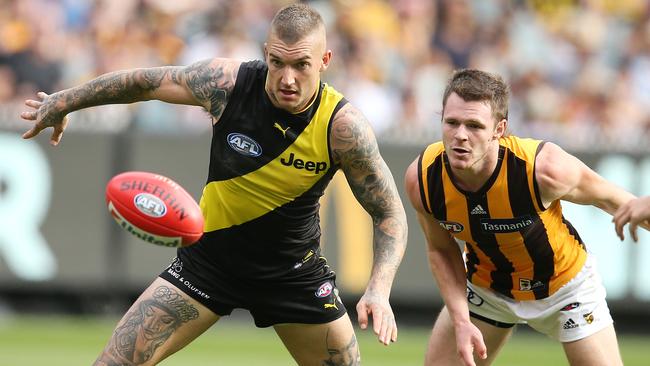 Richmond’s Dustin Martin battles for the loose ball with Hawthorn’s Blake Hardwick. Picture: Michael Klein