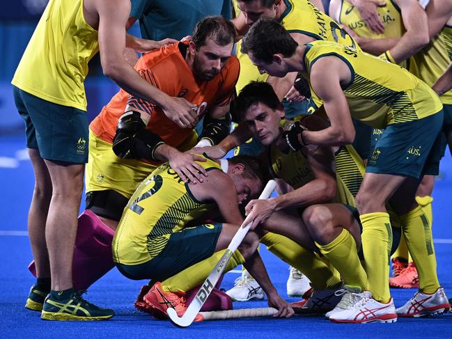 The Kookaburras get around shattered star Jake Whetton. Picture: AFP