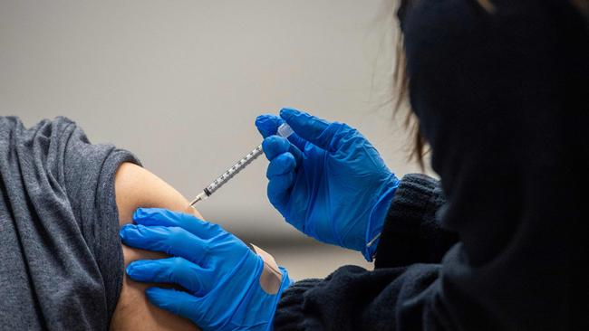 A man is inoculated with the Pfizer-BioNTech Covid-19 vaccine. (Photo by Joseph Prezioso / AFP)