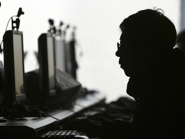 FILE - In this Jan 23, 2008 file photo, a computer user is silhouetted with a row of computer monitors at an Internet cafe in Shenyang, in northern China's Liaoning province. Word leaked out slowly, spread by tech-savvy folks on Twitter: Internet porn is now openly available in China. Is the new access to online pornography a policy change or a trap? It throws into sharp relief what many see as the main mission of China's aggressive Internet censorship: blocking content that might challenge the political authority of the communist government. (AP Photo/File) **CHINA OUT **