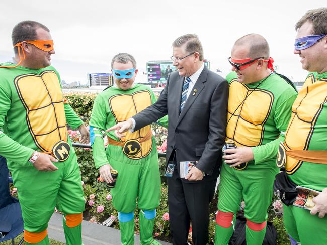 Victorian Premier Denis Napthine with Teenage Mutant Ninja Turtles who asked him what he was going to do about the state of the sewers. Picture: Jason Edwards.