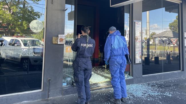 Forensic investigators were at the Napier St, Essendon fire about 9am as police interviewed owners of neighbouring businesses. Picture: Himangi Singh