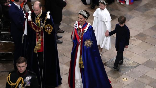 William, Catherine, Princess Charlotte and Prince Louis during the coronation ceremony. The Princess of Wales wore the Royal Victorian Order mantle over her McQueen gown. Picture: AFP