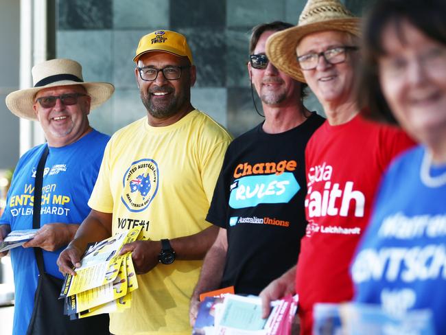 Pre polling for the upcoming federal election continues, even on the public holiday. Palmer United Party supporter Hans Batzke hands out how to vote cards to voters, flanked by (L-R) Gilbert Moase, Steve Blacklow of the Australian Council of Trade Unions and Edin Corhodzic. PICTURE: BRENDAN RADKE