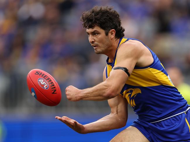 PERTH, AUSTRALIA - JUNE 08: Tom Barrass of the Eagles handballs during the round 13 AFL match between West Coast Eagles and North Melbourne Kangaroos at Optus Stadium, on June 08, 2024, in Perth, Australia. (Photo by Paul Kane/Getty Images)