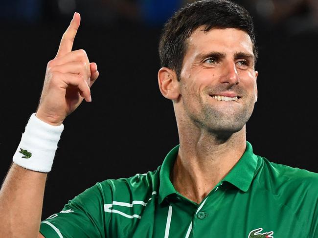 (FILES) This file photo taken on January 30, 2020 shows Serbia's Novak Djokovic celebrating after beating Switzerland's Roger Federer during their men's singles semi-final match on day 11 of the Australian Open tennis tournament in Melbourne. - World number one Novak Djokovic won a stunning victory on January 10, 2022 over the Australian government, overturning the cancellation of his visa on Covid-19 health grounds, and ending his detention. (Photo by William WEST / AFP) / -- IMAGE RESTRICTED TO EDITORIAL USE - STRICTLY NO COMMERCIAL USE --