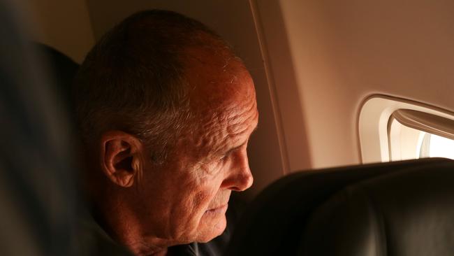 Chris Dawson is escorted by NSW Police whilst being flown from Queensland to NSW to face charges of murder over the death of his wife Lyn Dawson IN 2018. Picture: Lyndon Mechielsen/ The Australian