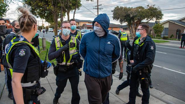 Officers clashed with a group of about 100 people who marched along a road in Dandenong on Wednesday. Picture: Jason Edwards