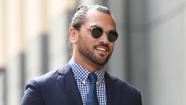 Karmichael Hunt smiles as he arrives at the Magistrates Court in Brisbane.