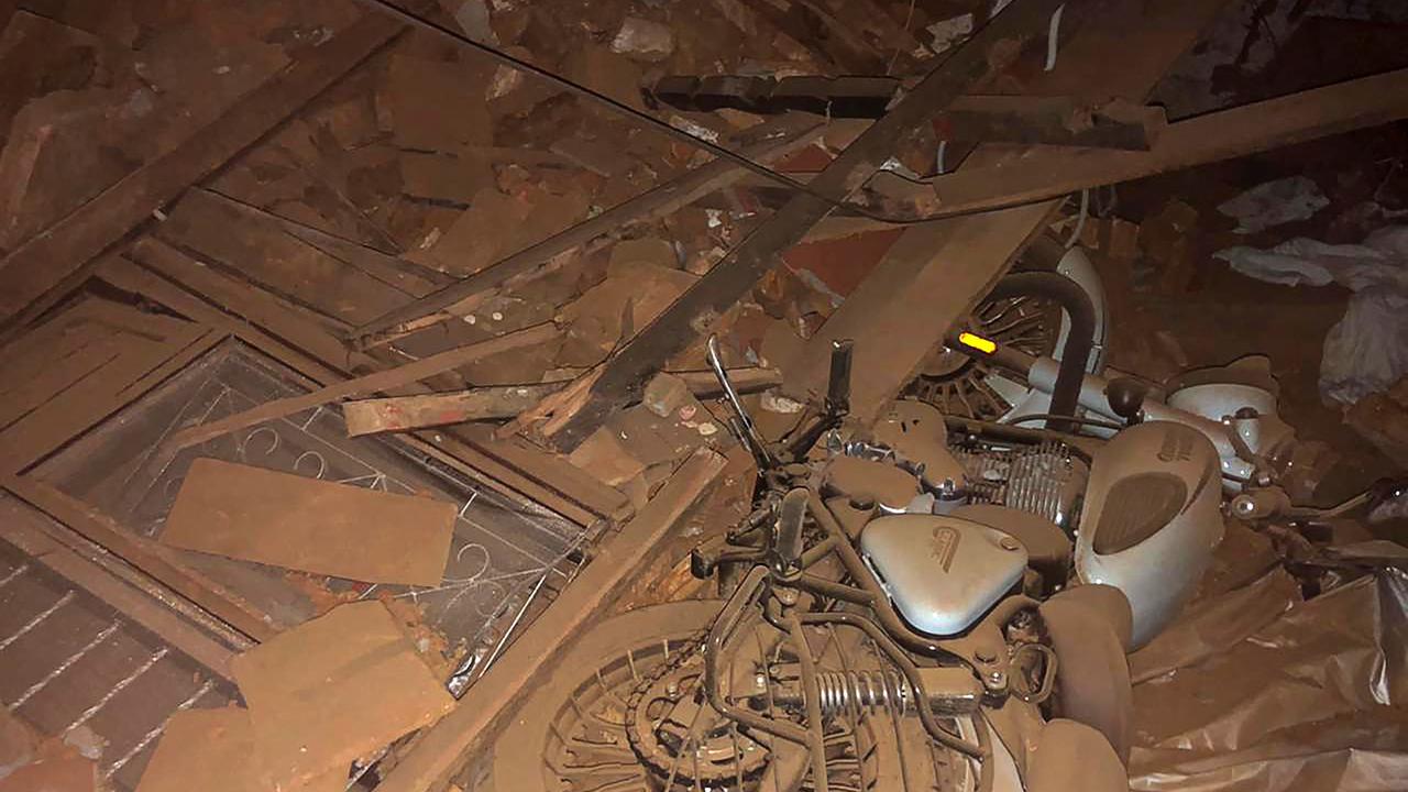 A motorcycle and broken windows are seen in the midst of the rubble in the aftermath of an earthquake in Jajarkot. Picture: AFP