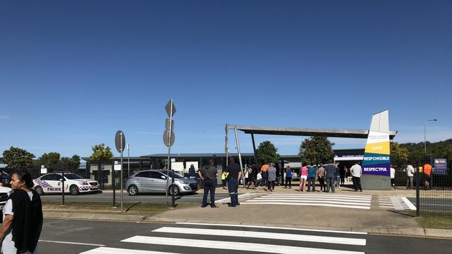 Parents gather out the front of Upper Coomera State College after the school went into lockdown following an alleged shooting threat.