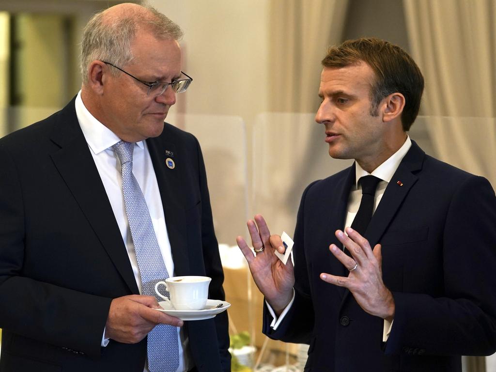 Prime Minister Scott Morrison and French President Emmanuel Macron talk before the G20 leaders make a short visit to the Fontana di Trevi before the start of the second day of the G20 in Rome. Picture: Adam Taylor