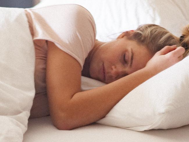 Attractive single woman at home, sleeping on the bed. The shot is executed with available natural light, and the copy space has been left. Shallow DOF. Soft focused.