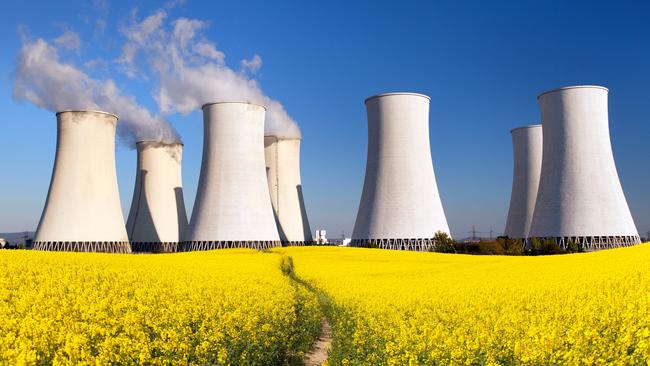 Panoramic view of Nuclear power plant Jaslovske, cooling tower, Bohunice with golden flowering field of rapeseed - Slovakia - two possibility for production of electric energy