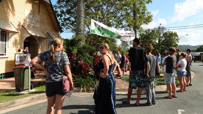 Members of the public line up on the road at Yandina as they wait to cast their vote in the Queensland state election. Picture: Lachie Millard