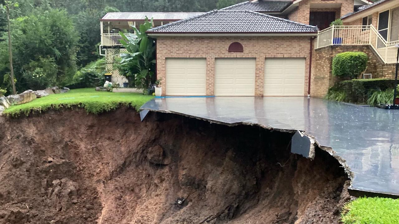 At the foot of the Blue Mountains, an image of a home teetering on the edge of a cliff at Emu Heights following a landslide has illustrated the staggering scale of damage from the floods. Picture: Twitter