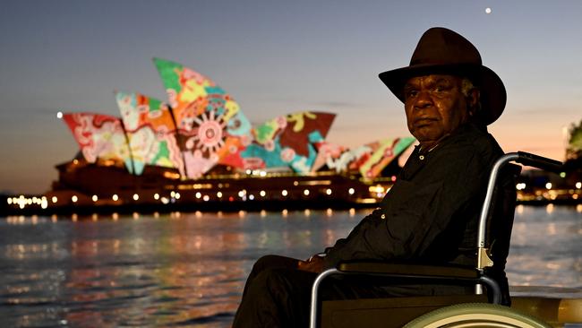 Western Desert artist and elder Yadjidta David Miller on the foreshore of Campbell Cove as his artwork is projected onto the Sydney Opera House at dawn on Australia Day. Picture: NCA NewsWire / Jeremy Piper