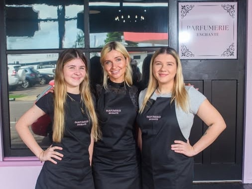 The small team at Parfumerie Enchante - owner Rachel Hobson (centre) with her staff Chelsea and Cheyenne in front of the new business on French St, Pimlico. The store is only open Thursday - Saturday.