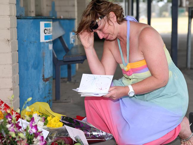 Luke's mum Rosie Batty at Tyabb cricket oval, looking through all the flowers and cards laid for her son in the wake of his death.