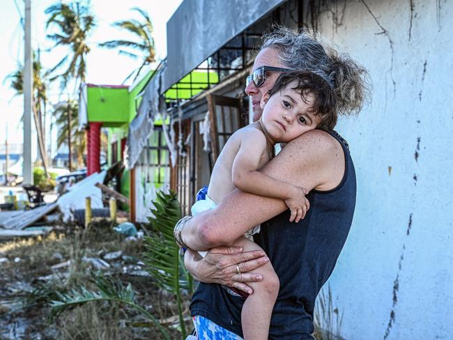 A woman of holds her son outside their home in the aftermath of Hurricane Ian in San Carlos Island, Florida. Picture: AFP