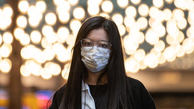 A woman wears a protective face mask in Sydney. Picture: AAP