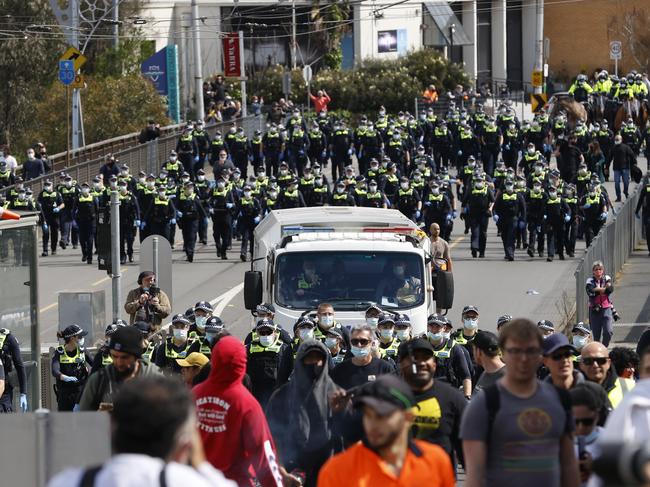 Police follow protesters on Church st Richmond. Picture: Alex Coppel