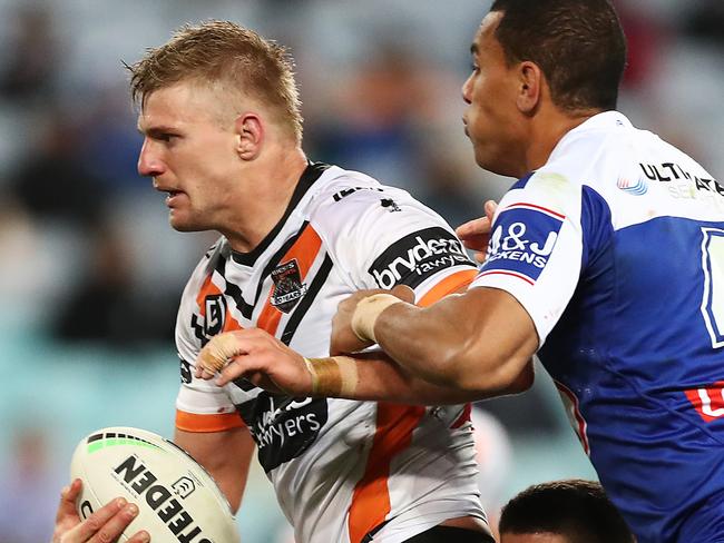 SYDNEY, AUSTRALIA - AUGUST 10: Luke Garner of the Tigers Is tackled during the round 21 NRL match between the Canterbury Bulldogs and the Wests Tigers at ANZ Stadium on August 10, 2019 in Sydney, Australia. (Photo by Mark Metcalfe/Getty Images)