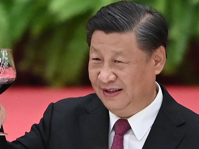 Chinese President Xi Jinping raises his glass after a speech by Premier Li Keqiang at a reception at the Great Hall of the People on the eve of China's National Day on September 30, 2021. (Photo by GREG BAKER / AFP)