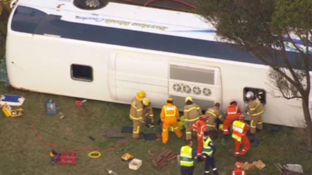 Emergency services are working to free the trapped people, believed to be mostly children, on board the bus. Photo: 7 News