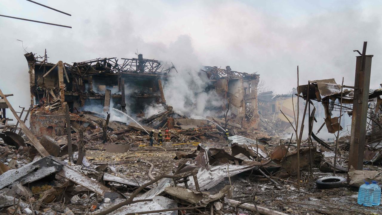 Firefighters spray water on a destroyed shoe factory following an air strike in Dnipro. Picture: AFP