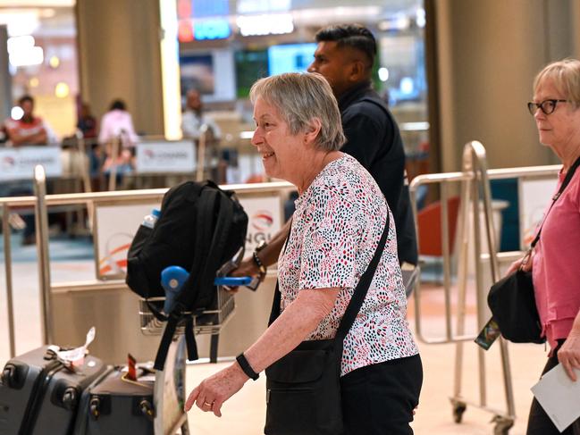 Those on board the flight arrive in Singapore. Picture: AFP