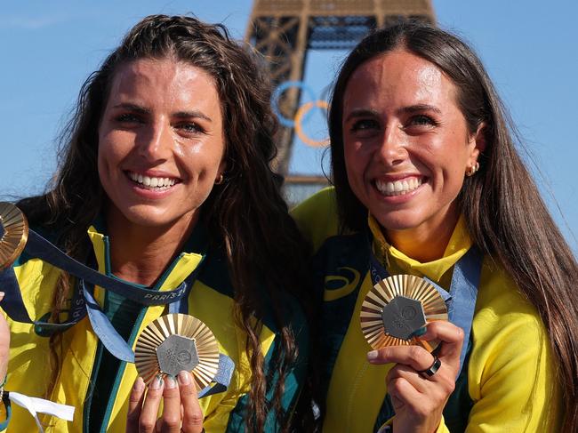 Australia's gold medallists and Jessica and Noemie Fox pose with their medals on stage at the Champions Park at Trocadero during the Paris 2024 Olympic Games in Paris on August 6, 2024, with the Eiffel Tower visible in the background. (Photo by Jack GUEZ / AFP)