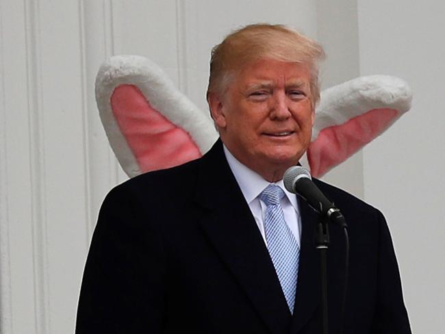 U.S. President Donald Trump appears on the South Portico of the White House with the Easter Bunny standing behind him as the annual White House Easter Egg Roll is held on the South Lawn of the White House in Washington, U.S., April 2, 2018. REUTERS/Carlos Barria     TPX IMAGES OF THE DAY - RC1B3D318750